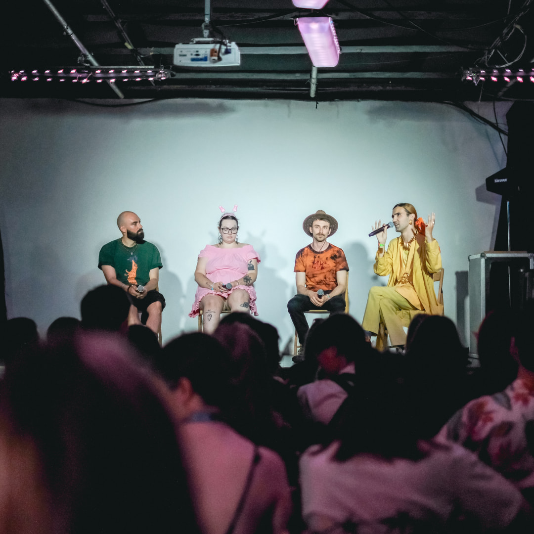 Speakers presenting at an educational charity lecture during KyivPride 2024